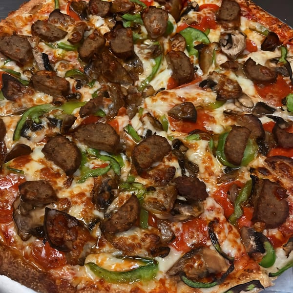 South St Pizzeria's pizza with sausage, green peppers, mushrooms, and melted cheese.
